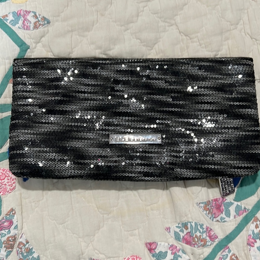 BCBG Sequin clutch with zipper closure interior has zipper & storage
